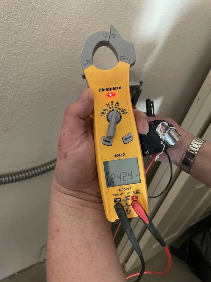 Voltage testing with clamp meter during Recessed Lighting Installation in Parker